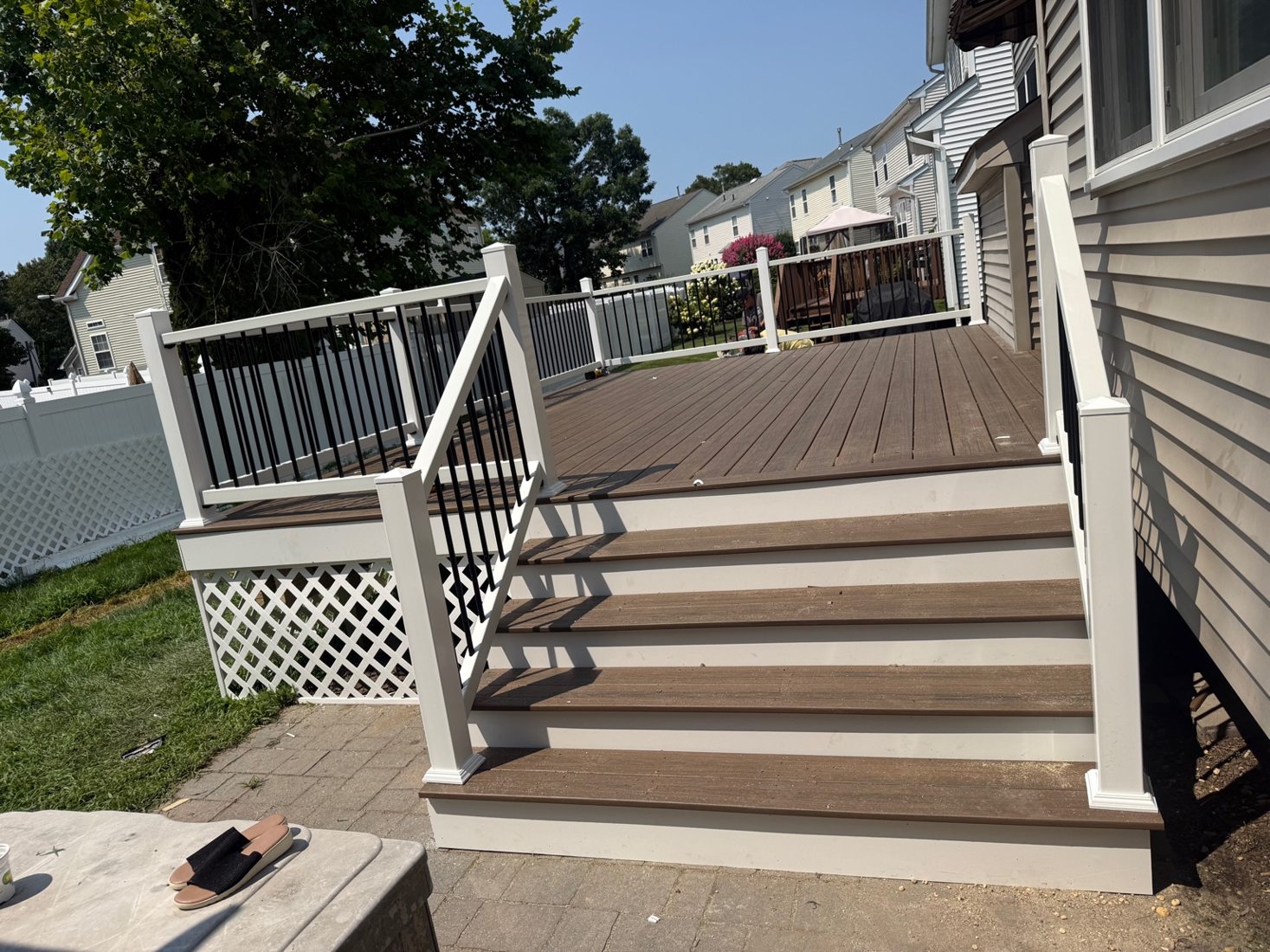 Finished composite deck with white and black railing